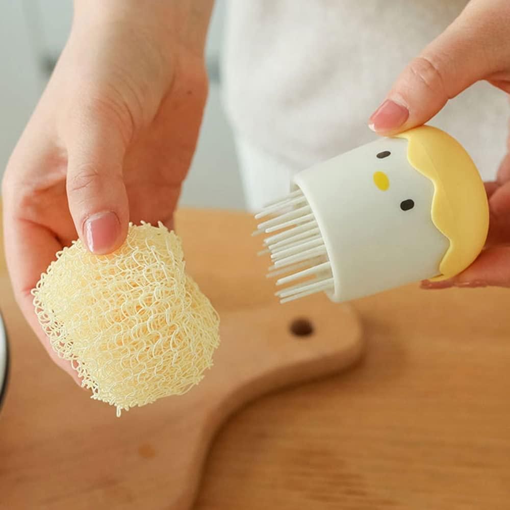 Person holding a brush and a sponge over a wooden surface