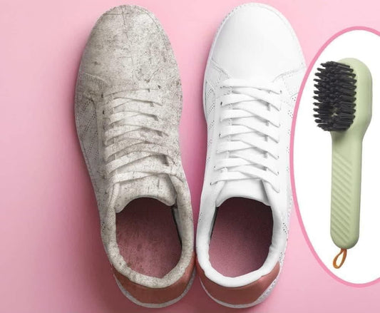 Pair of dirty sneakers next to a white sneaker and a brush on a pink background