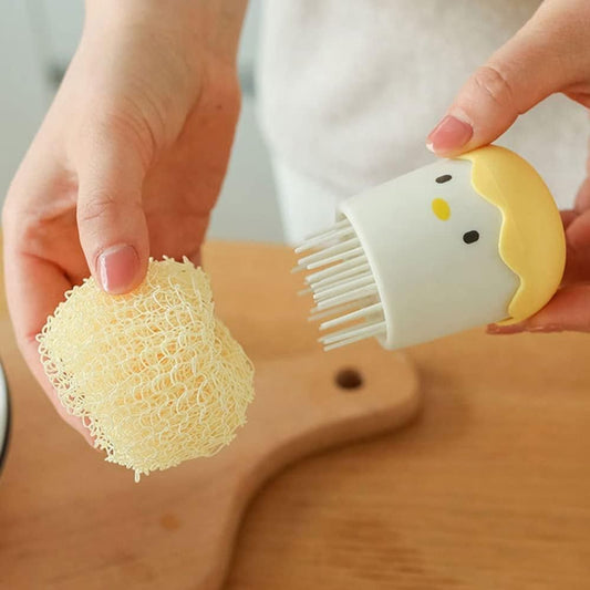 Person holding a brush and a sponge over a wooden surface